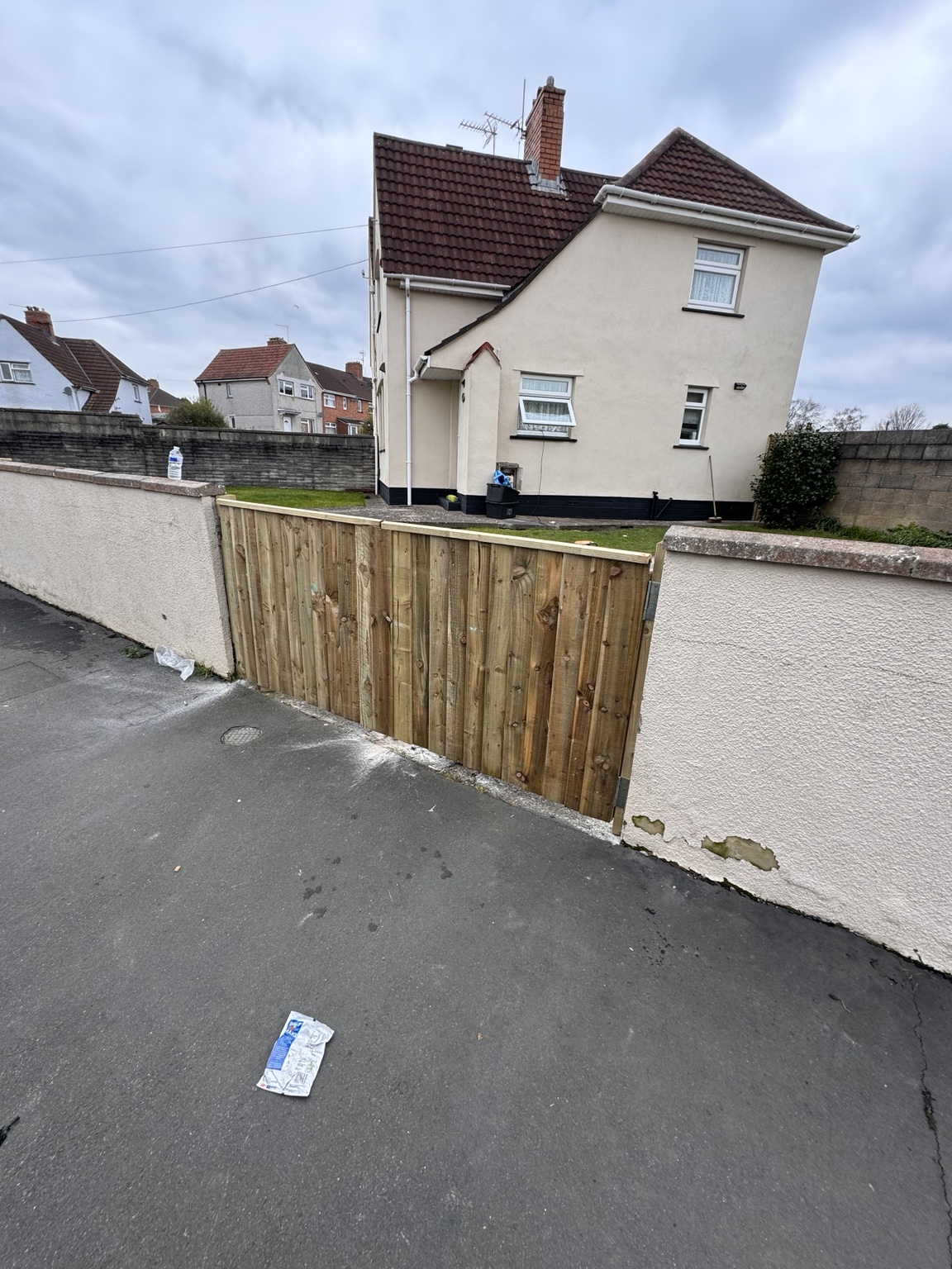 Angled view of timber side gate and boundary wall